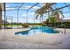 Inviting pool within a screened enclosure, complemented by landscaping and scenic views of the backyard at 7303 Spring Mountain Ln, Yalaha, FL 34797