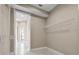 Generous walk-in closet featuring built-in shelving and tile flooring, providing functional organization at 7303 Spring Mountain Ln, Yalaha, FL 34797