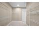 Spacious walk-in closet with ample shelving and neutral-toned walls offering plenty of storage at 7303 Spring Mountain Ln, Yalaha, FL 34797