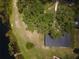 Picturesque aerial view of a home nestled among mature trees on a waterfront property at 81 N Carol Ave, Mascotte, FL 34753