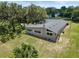 Beautiful aerial view of a charming home surrounded by mature trees and a spacious lawn at 81 N Carol Ave, Mascotte, FL 34753