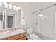 Updated bathroom featuring a subway tile shower, granite vanity, and updated toilet at 81 N Carol Ave, Mascotte, FL 34753