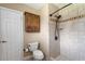 Bathroom features a standing shower, dark hardware and light tile, plus a dark wooden cabinet at 81 N Carol Ave, Mascotte, FL 34753
