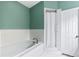 Bathroom features tile flooring and a white shower-tub combination with a shower curtain at 81 N Carol Ave, Mascotte, FL 34753