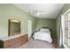 Bright bedroom featuring a ceiling fan, neutral carpet, and a window for plenty of natural light at 81 N Carol Ave, Mascotte, FL 34753