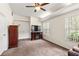 This carpeted bedroom includes a closet, electric fireplace, and a ceiling fan with lighting at 81 N Carol Ave, Mascotte, FL 34753