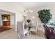 Bright dining room with a chandelier, decorative plant, and tile flooring at 81 N Carol Ave, Mascotte, FL 34753