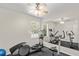 Bright exercise room with multiple windows, ceiling fan, mirrored wall and exercise equipment at 81 N Carol Ave, Mascotte, FL 34753