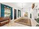 Spacious foyer with piano, dark door, bright windows with blue curtains, tile flooring, leading into the dining room at 81 N Carol Ave, Mascotte, FL 34753