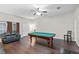 Spacious game room featuring a pool table and dark hardwood flooring at 81 N Carol Ave, Mascotte, FL 34753