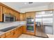 Well-equipped kitchen featuring stainless steel appliances, granite countertops, and light wood cabinetry at 81 N Carol Ave, Mascotte, FL 34753