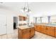 Spacious kitchen with granite island, stainless appliances, and wood cabinetry overlooking living spaces at 81 N Carol Ave, Mascotte, FL 34753