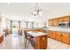 Open kitchen featuring a granite island and breakfast bar, wood cabinets, and stainless appliances at 81 N Carol Ave, Mascotte, FL 34753