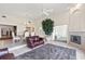Open-concept living room features a fireplace, tile floors, and an adjacent dining area at 81 N Carol Ave, Mascotte, FL 34753