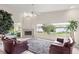 Bright living room with a fireplace, scenic lake views and cozy seating at 81 N Carol Ave, Mascotte, FL 34753
