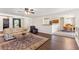 Cozy living room with hardwood floors, comfortable seating, and easy access to the dining area at 81 N Carol Ave, Mascotte, FL 34753