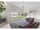 Bright living room with vaulted ceilings, a fireplace, and scenic lake views at 81 N Carol Ave, Mascotte, FL 34753