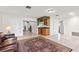 Bright living room with a decorative bar, tile flooring, and a large decorative rug at 81 N Carol Ave, Mascotte, FL 34753