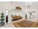 Bright living area with soaring ceilings, tile flooring, neutral walls, and open access to connected rooms at 81 N Carol Ave, Mascotte, FL 34753