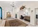 Open living area with high ceilings, tile floors, a decorative wall hanging, and seamless access to the dining room at 81 N Carol Ave, Mascotte, FL 34753