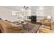 Inviting living room with fireplace, hardwood floors, large area rug, and natural light at 81 N Carol Ave, Mascotte, FL 34753