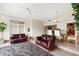Spacious living room with vaulted ceilings, tile floors, and open to the dining area at 81 N Carol Ave, Mascotte, FL 34753