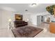 Comfortable living room featuring a decorative rug, modern lamps and tropical artwork at 81 N Carol Ave, Mascotte, FL 34753