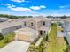 Aerial view of a two story home with manicured lawn and two car garage at 853 Blue Creek Dr, Haines City, FL 33844
