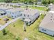 Aerial view of a residential neighborhood showcasing the house with a charming backyard at 853 Blue Creek Dr, Haines City, FL 33844