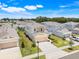 Aerial view of a two story home with a two car garage, green lawn, and landscaping at 853 Blue Creek Dr, Haines City, FL 33844