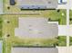Aerial view of a well-kept house with a large roof and a manicured lawn at 853 Blue Creek Dr, Haines City, FL 33844