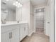 Bathroom featuring double vanity sinks, wood-look tile flooring, and a walk-in shower at 853 Blue Creek Dr, Haines City, FL 33844