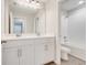Bathroom featuring double vanity sinks, tile flooring and a tub shower at 853 Blue Creek Dr, Haines City, FL 33844
