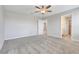 Neutral bedroom featuring ceiling fan, plush carpet, and ample natural light from the doorway at 853 Blue Creek Dr, Haines City, FL 33844