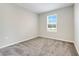 This carpeted bedroom features a window that lets in plenty of natural light at 853 Blue Creek Dr, Haines City, FL 33844