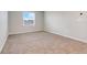 A well lit, carpeted bedroom features a window that lets in plenty of natural light at 853 Blue Creek Dr, Haines City, FL 33844