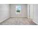 A carpeted bedroom features a window that lets in plenty of natural light at 853 Blue Creek Dr, Haines City, FL 33844