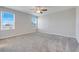 Bright bedroom featuring plush carpet, ceiling fan, and large windows, offering ample natural light at 853 Blue Creek Dr, Haines City, FL 33844