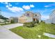Inviting two-story home with a red front door, manicured lawn, and a spacious two-car garage at 853 Blue Creek Dr, Haines City, FL 33844