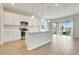 Bright kitchen features pendant lighting over the island and stainless steel appliances at 853 Blue Creek Dr, Haines City, FL 33844