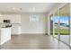 Bright kitchen area with modern tile floors and glass doors leading to the backyard at 853 Blue Creek Dr, Haines City, FL 33844
