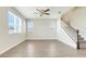 Open living area with large windows, neutral walls, tile flooring, and a staircase at 853 Blue Creek Dr, Haines City, FL 33844