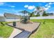 Well-maintained community playground with slides, swings, and seating areas at 853 Blue Creek Dr, Haines City, FL 33844