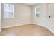 Bright, empty room with two windows, neutral walls, white trim, and tile flooring at 853 Blue Creek Dr, Haines City, FL 33844