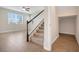 Bright living area with staircase and tile flooring; sunlight streams through large window at 853 Blue Creek Dr, Haines City, FL 33844