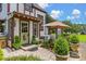Inviting backyard area with a landscaped patio, a green door, and manicured plants at 9233 Silver Lake Dr, Leesburg, FL 34788