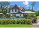 Private backyard with a fenced pool area, patio seating, and mature trees providing shade at 9233 Silver Lake Dr, Leesburg, FL 34788