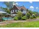 Spacious backyard with mature landscaping featuring a fenced in pool and lounge area at 9233 Silver Lake Dr, Leesburg, FL 34788