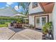 Paver patio with outdoor dining, potted plants, and a view of the pool at 9233 Silver Lake Dr, Leesburg, FL 34788