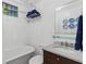 Classic bathroom with a vintage-style vanity, soaking tub, and elegant decor at 9233 Silver Lake Dr, Leesburg, FL 34788